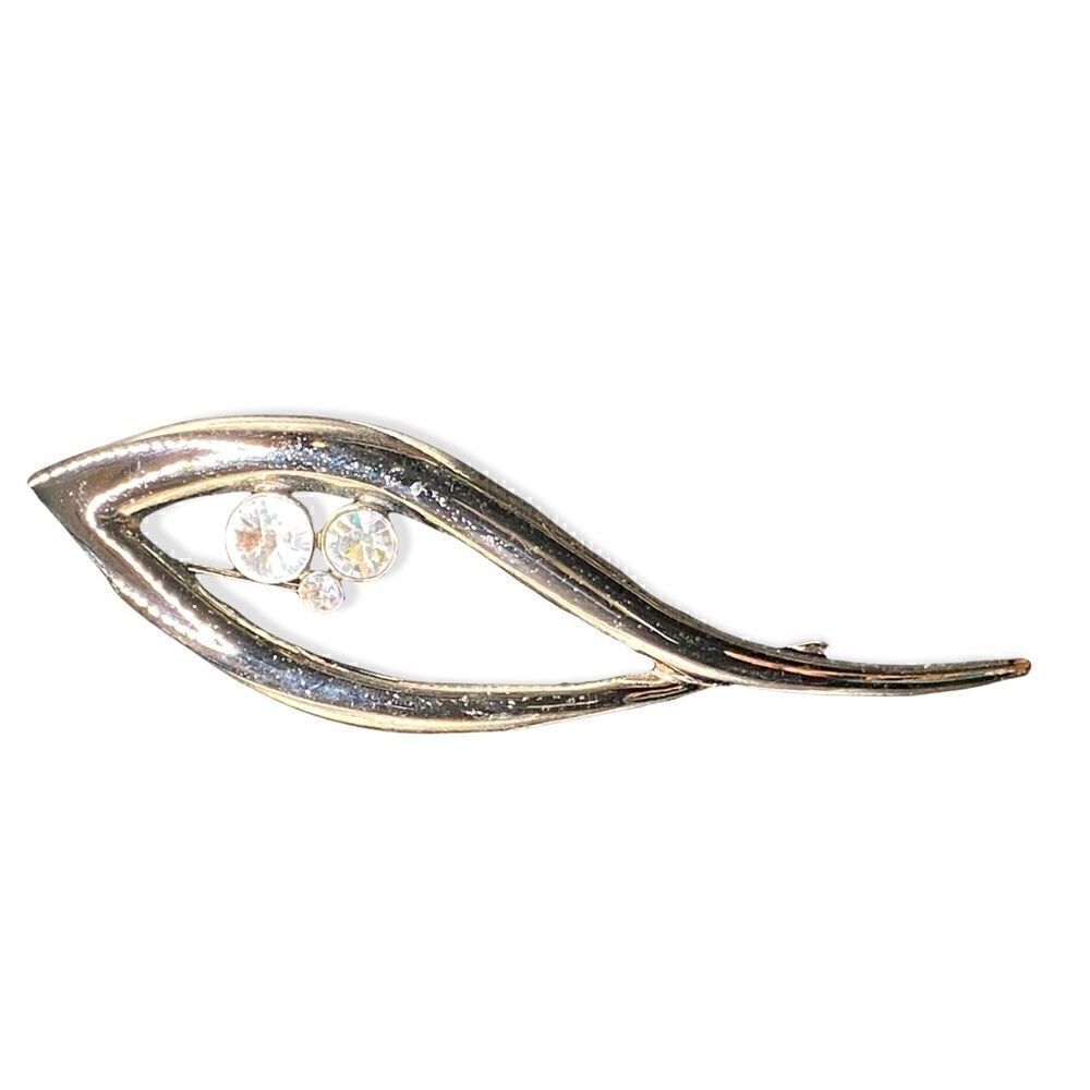 Black metal eye shaped brooch with 3 rhinestones intact